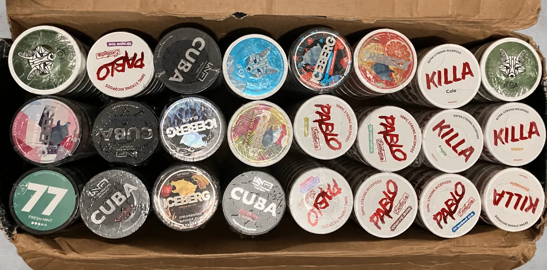 A carton of assorted nicotine pouch cans received for Canadian orders.