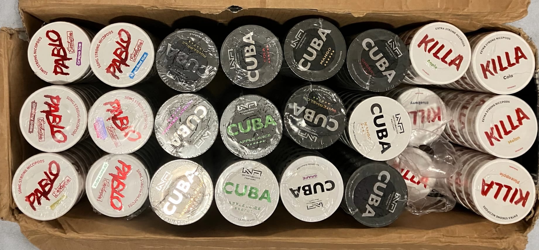 A carton of Killa, Cuba and Pablo cans opened for checking before the stock is shelved.